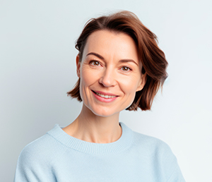 Smiling happy woman in her 40s wearing sky blue sweater